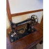 Image 2 : Antique Singer sewing machine, likely manufactured in the early 1900s, housed within its original wo