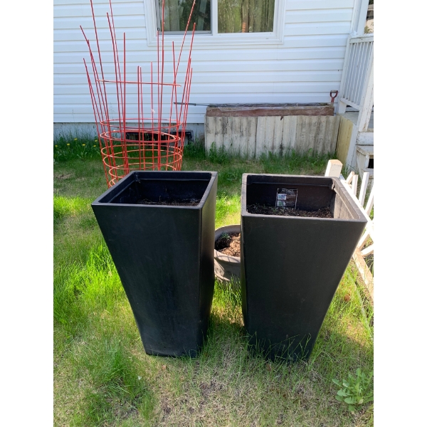 Two Black Tall Plastic Planters with Additional Garden Accessories