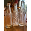 Image 5 : Atique clear soda bottles Coca-Cola wishing well whistle soda, Calgary soda and two Pepsi bottles al