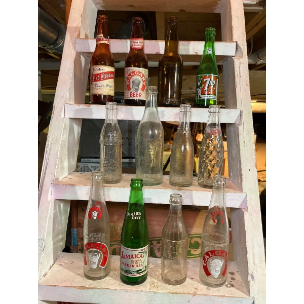 collection of antique bottles, including red ribbon, logger beer, Calgary beer, BC breweries from Va
