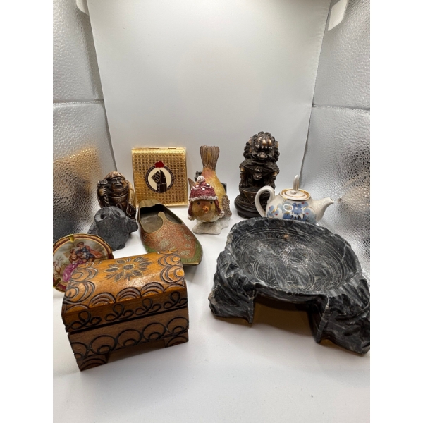 collection of items from around the world, including small, teapot, copper boot, small wooden handma