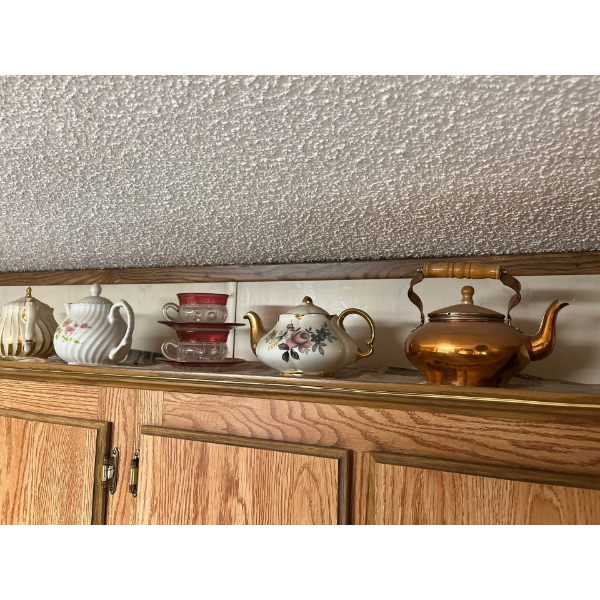 Collection of tea pots cookie Jars & various tin canisters .