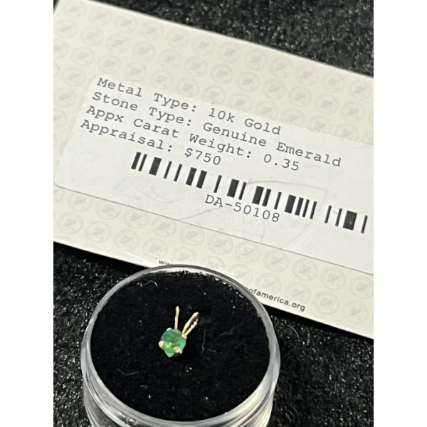 10 K gold natural Emerald  weighing 0.35 with certificate of appraisal and authentic card