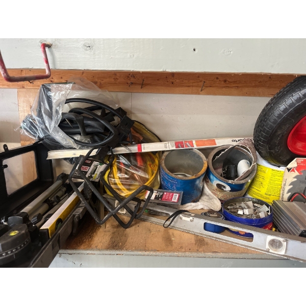 contents of shelf, including a GE garbage disposal, Kenwood speakers, rolling knee cart, laser level