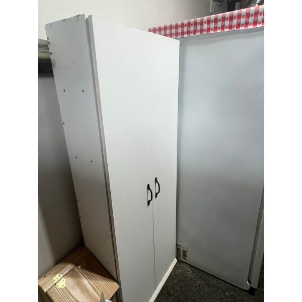 White simple cabinet with art supplies inside. 
