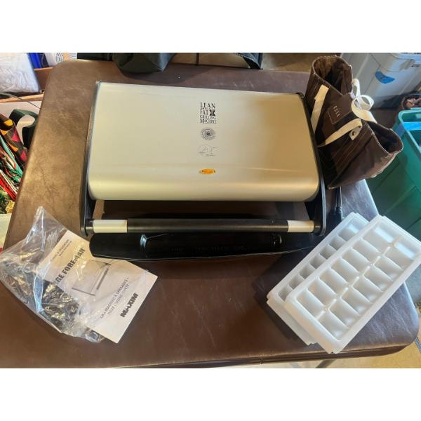 George Foreman lean mean fat grilling machine, ice cube trays, and vinyl lunchbox. 

