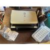 Image 1 : George Foreman lean mean fat grilling machine, ice cube trays, and vinyl lunchbox. 

