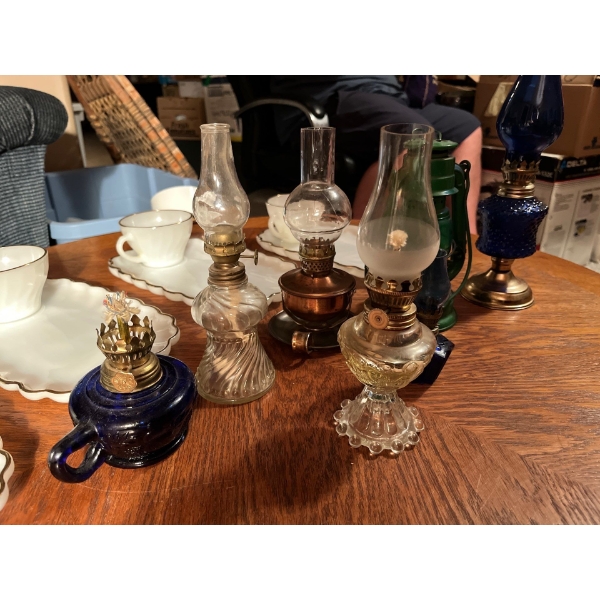 Collection of small lanterns and four milk glass teacup and saucers
