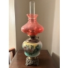 Image 1 :  Vintage kerosene oil lamp, characterized by its hand-painted glass base featuring floral motifs, a 