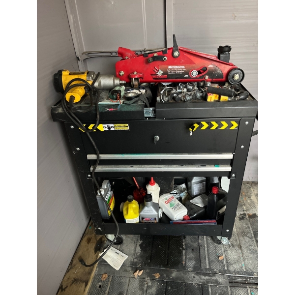 Black rolling tool chest with contents, including impact drill and Mastercraft Jack with small white