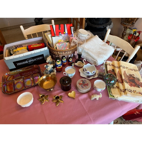  A selection of items, including nesting dolls, tea, cups, birthday items, table cloths bra candle h