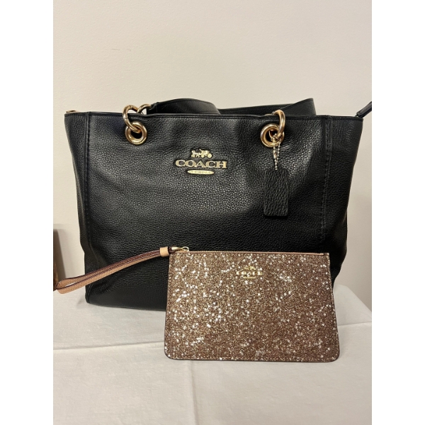 black leather Coach tote bag paired with a glittery small Coach wristlet. 