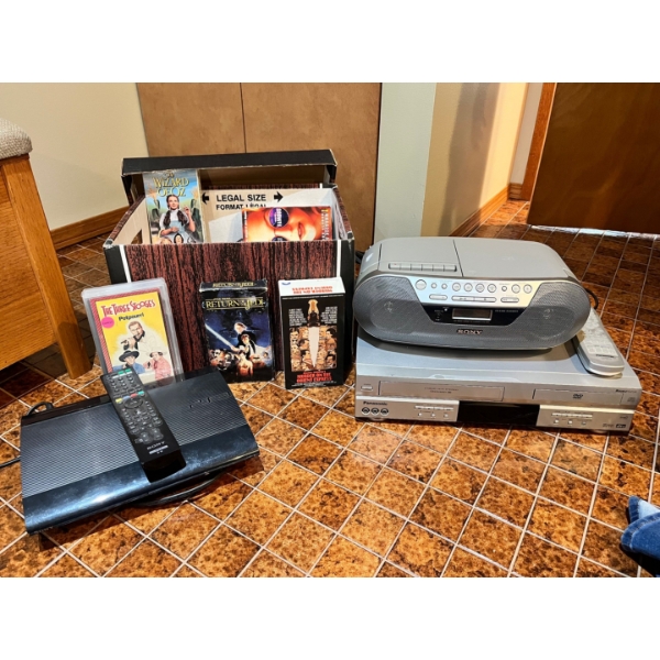 Sony PS3 with remote, Sony Radio/CD Player, Panasonic VHS/DVD player with an assortment of VHS