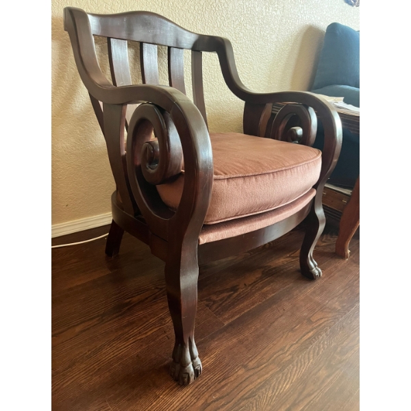 Armchair in an Empire style, crafted from dark wood with scrolled arms and distinctive carved feet