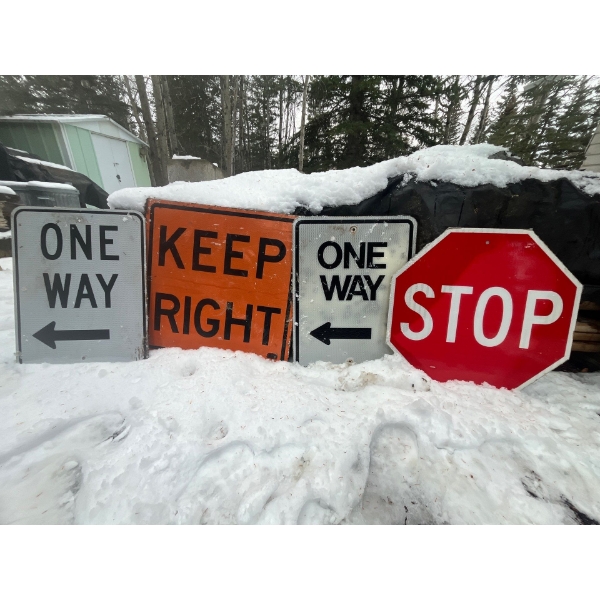 Metal road signs, one stop sign and 2 one way and a wood Orange Keep right .