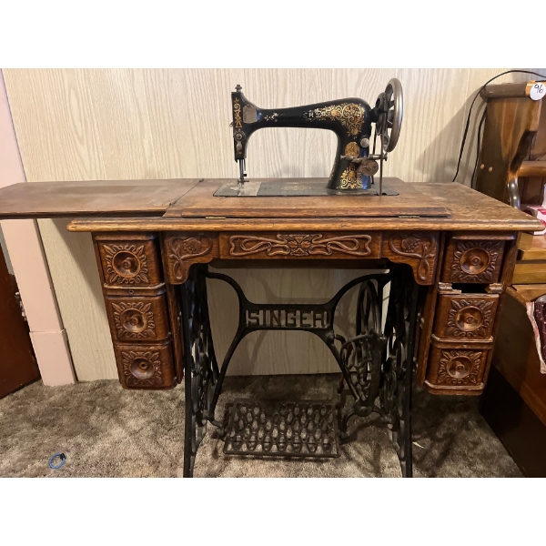 antique singer, sewing machine paddle driven with beautifully hand, carved sewing cabinet