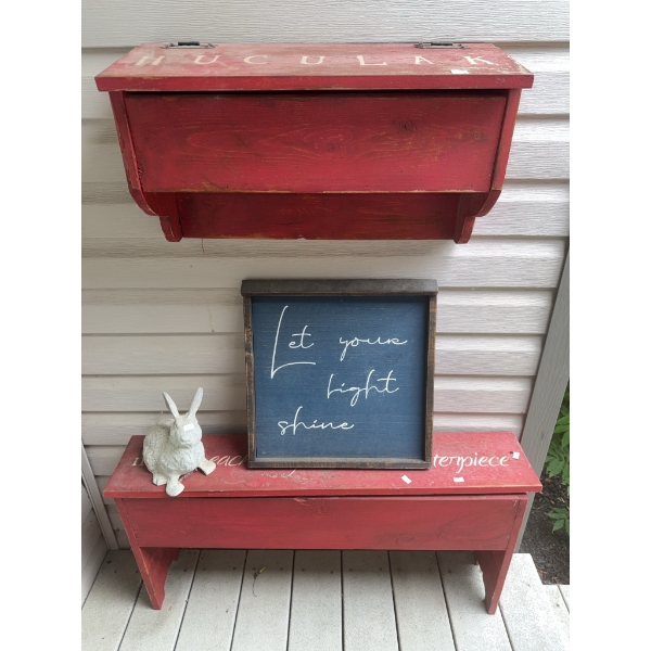 Two Red Wooden Benches with Decorative Sign and Rabbit Figurine