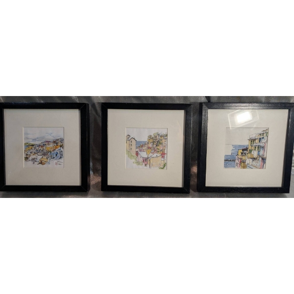Three Framed Artwork Pieces Depicting Urban Landscapes