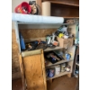 Image 1 : shelf with contents, including saws, cutoff, saws, electric drills, painting supplies, and a number 