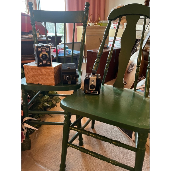 two antique green chairs and three antique vintage cameras brownie Hawkeye and GEVEBOK all in good c
