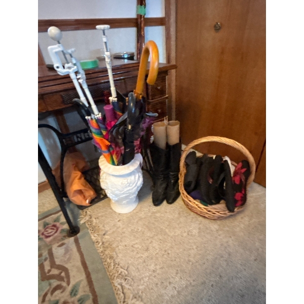 variety of umbrellas, sandals, and a pair of black boots, including basket and ceramic umbrella hold