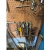 Image 5 : pegboard with various tools, including bolt cutters gear, polars, hacksaw, bungee cords, vice grips,