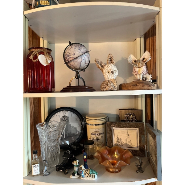 Shelf with contents with small collectibles .