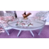 Image 2 : Glass Patio Table with Metal Frame, Two Chairs, Cushions, and Decorative Accents