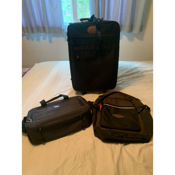 Three Travel Bags Including Suitcase, Carry-On Bag, and Backpack