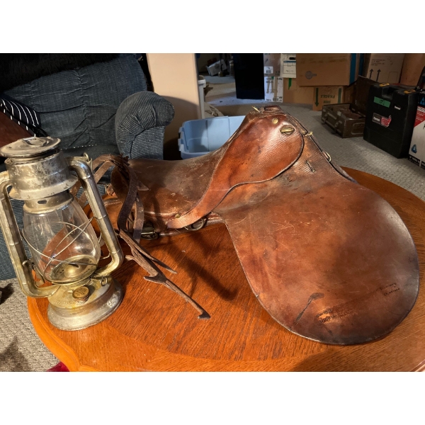 Antique saddle with antique lamp and large traps