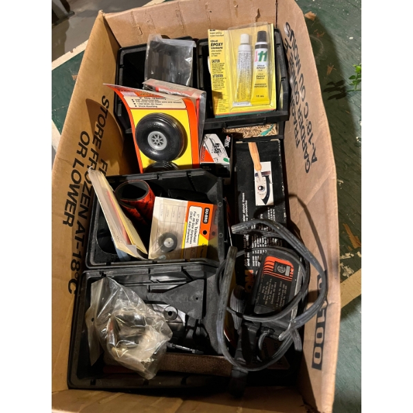 Box of miscellaneous remote control airplane, parts, wheels, and number of other items