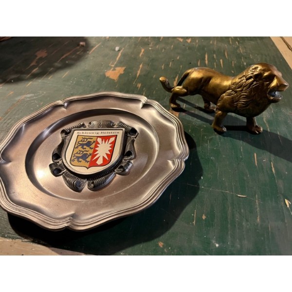 small brass lion and a pewter SCHLESWIG -HOLSTEIN collectable plate