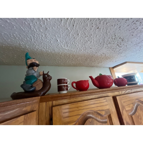 collection of teapots, gnomes, and number of other ceramic items, many of which are handmade