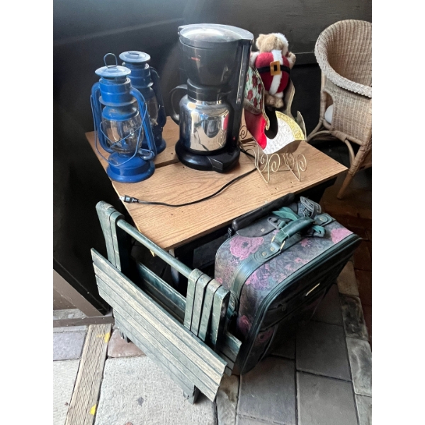 Coffee pot, lanterns, little table, and suitcase.

