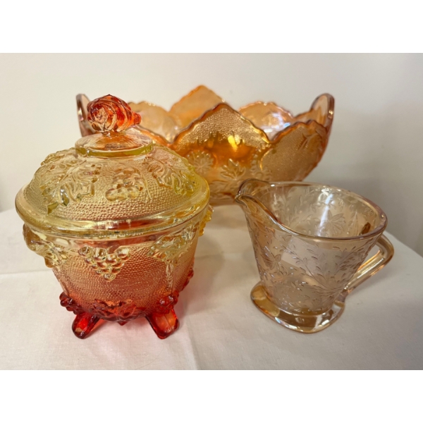 vintage Jeannette Glass footed bowl in the Lombardi pattern, featuring a marigold iridescence. 