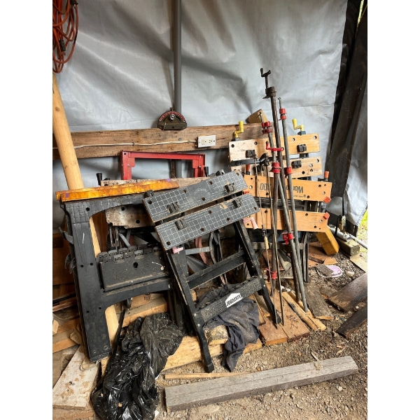 Five workbenches and a number of different size clamps And two sawhorses