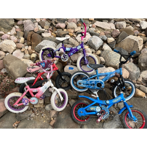 collection of five kids bikes