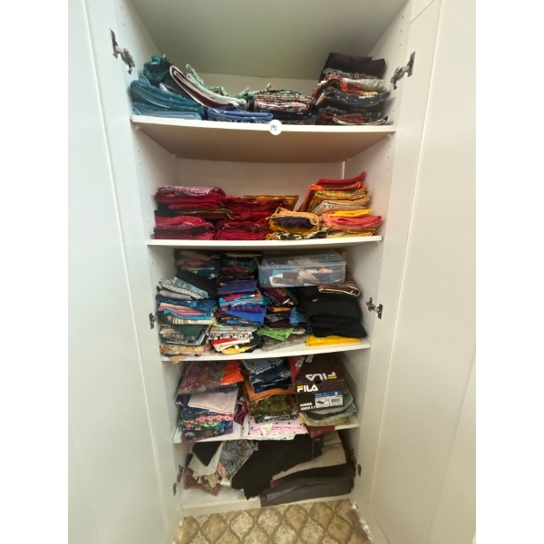 several different bolts of fabric some are already cut ready for quilting. Lots of reds greens and f