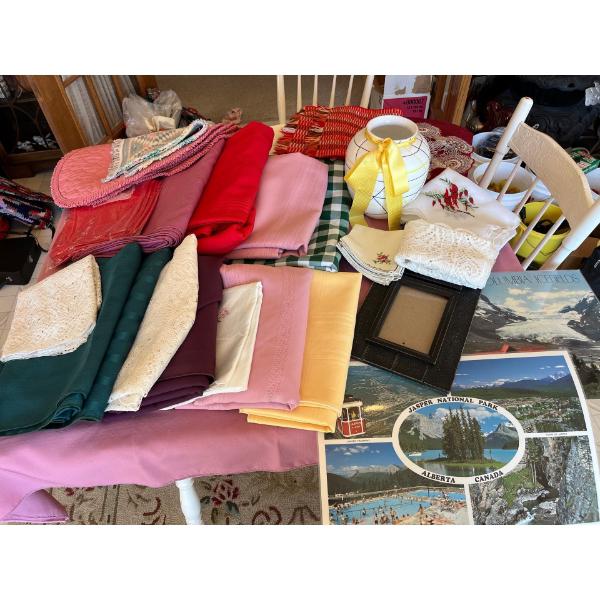 assortment of fabric table cloths, placemats napkins, and collectable Jasper national Park, placemat