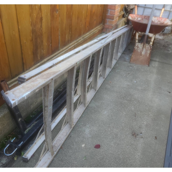 Aluminum Extension Ladder, Steel Wheelbarrow, and Metal Tow Bars Lot