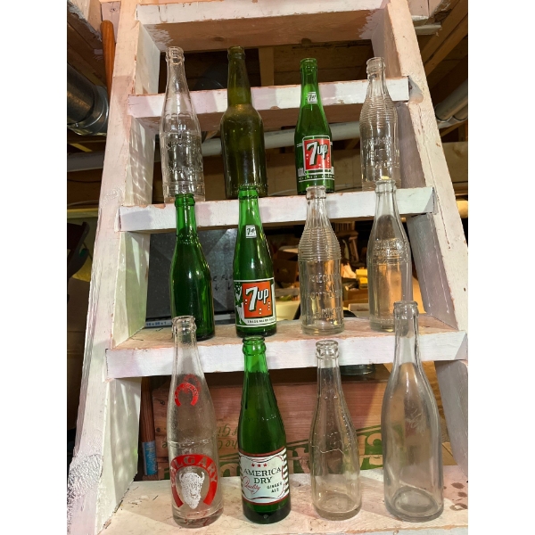  variety of antique soda bottle collection. Including 7-Up, American dry Canada dry Regina bottlers 