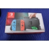 Image 1 : Nintendo Switch Console with Neon Blue and Red Joy-Con Controllers
