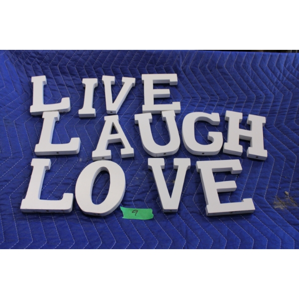 Painted white wooden letters spelling 'Live Laugh Love'. 