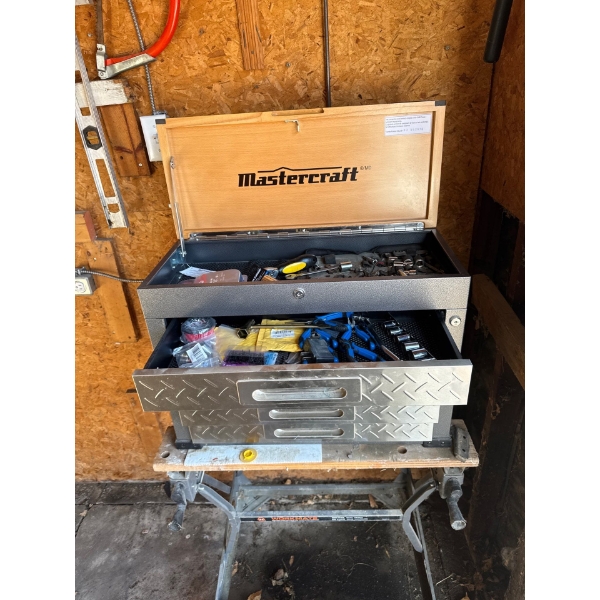 Mastercraft tool chest sitting on top of a Black & Decker Workmate portable workbench.
The Mastercra
