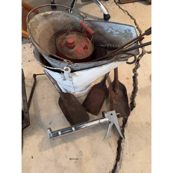 White metal bucket, red metal can with handle, three shovels, spring-handled tongs, and a metal grea