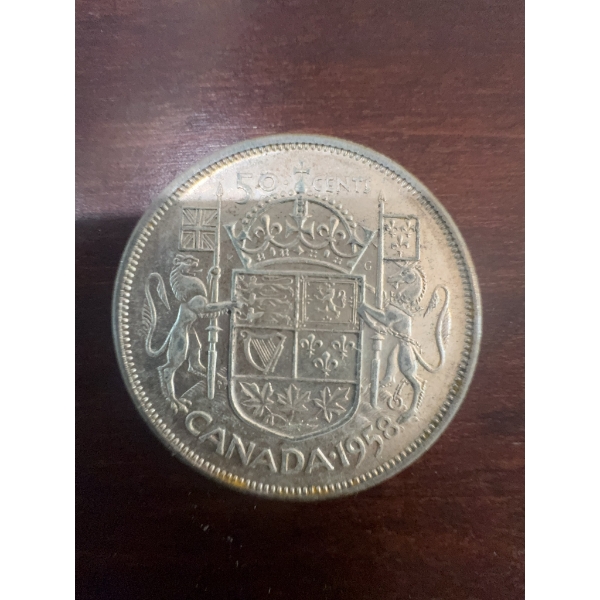 1958 Canadian 50 cents coin featuring the young portrait of Queen Elizabeth II and the Canadian coat