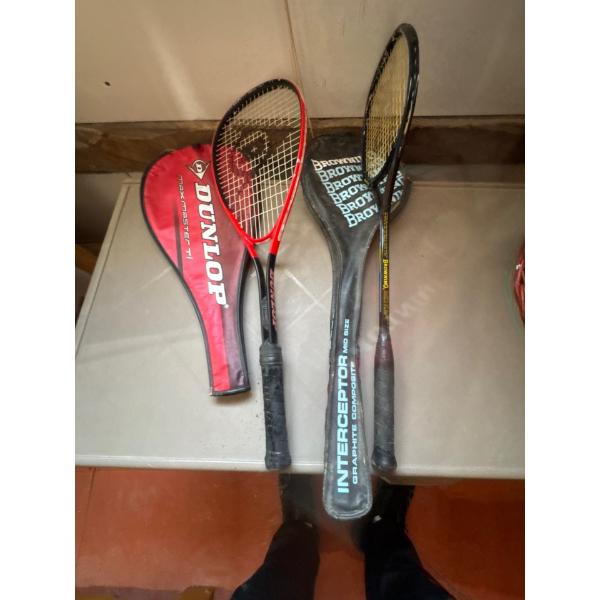 Two vintage rackets with their respective covers, one Dunlop squash rackets, specifically including 