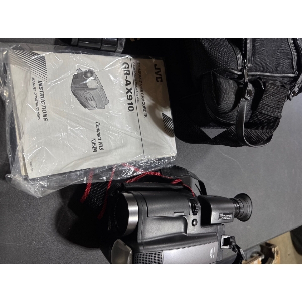 Vintage compact VHS camcorder g r dash a x nine ten with camera bag, camera, and instructions.