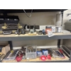 Image 1 : All items on these two shelves including a hand saw, full thing of grease, tools, nuts and bolts, fo