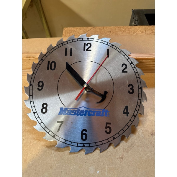  Mastercraft saw blade shop clock is a themed wall clock featuring a circular steel saw blade dial, 